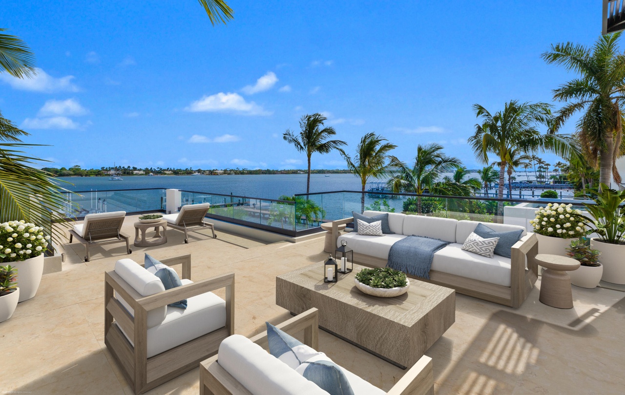 Upper outdoor lounge overlooking the water and surrounding palms.