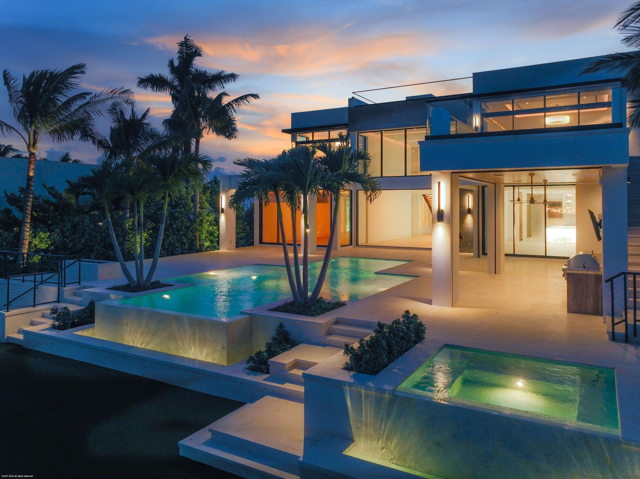 Pool terrace extending toward the Intracoastal waterway at dusk.