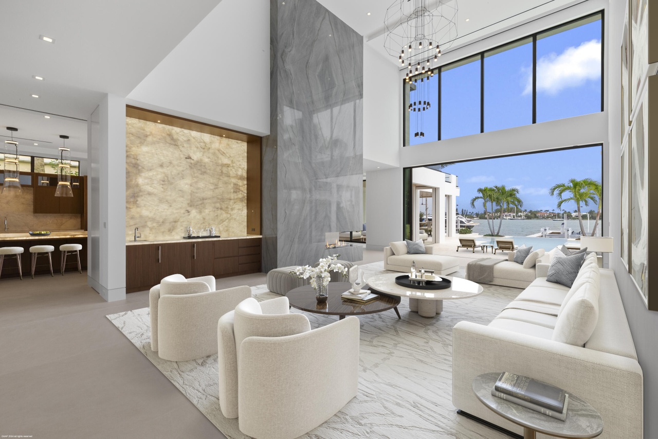 Double-height living room with waterfront views and refined contemporary finishes.