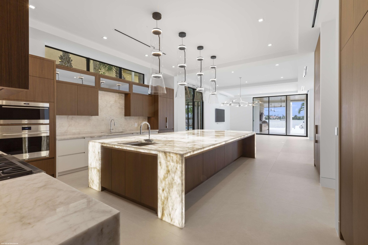 Stone kitchen island and warm millwork inside the open-plan interior.